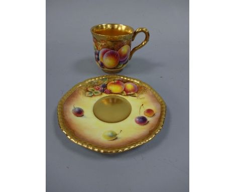 A ROYAL WORCESTER COFFEE CAN AND SAUCER, with hand painted peach, apple and cherry decoration to mossy bank, gilt borders and