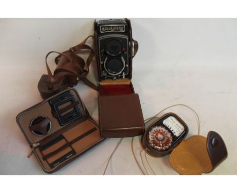 A ROLLEICORD VA TWIN LENS REFLEX CAMERA in original leather case with various accessories including a Weston Master III light