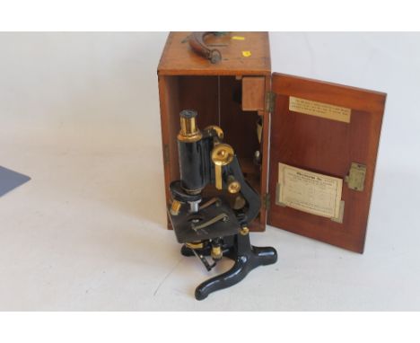 AN EARLY 20TH CENTURY "W. WATSON AND SONS LTD" SERVICE MICROSCOPE, in box together with extra lens, card inside dated 1928