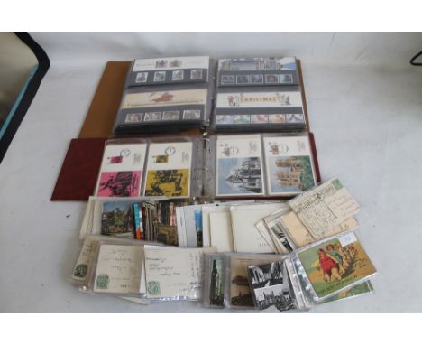 A BOX OF POSTCARDS to include some of local interest, an album of first day covers and another of presentation stamp packs