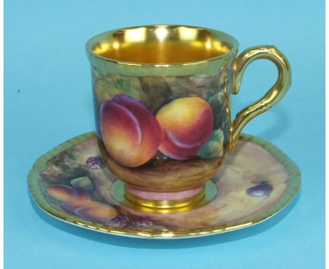 A Royal Worcester cabinet cup and saucer, hand painted with peaches, blackberries and grapes, signed J Skerrett, the cup with