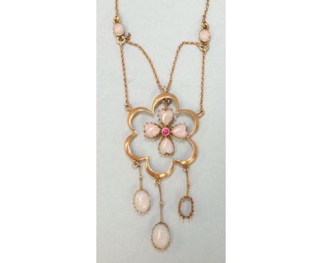 An Edwardian necklace set four heart-shaped opals and a ruby, within a six-lobed frame, with three opal drops below, one sett