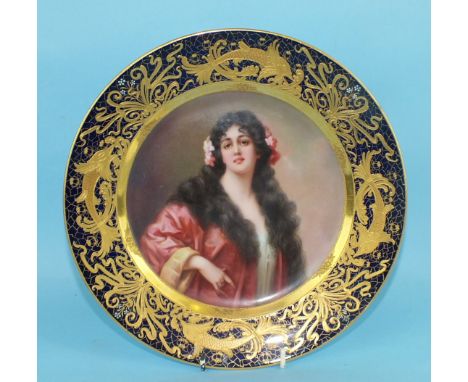A 19th century "Vienna" porcelain plate painted with a half-length portrait of a lady, signed Melzer, within an elaborate gil