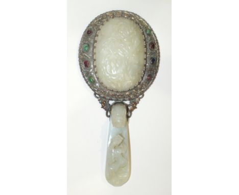 A late-19th century Chinese jade-set plated-metal hand mirror with white jade belt-hook handle carved with a dragon and drago