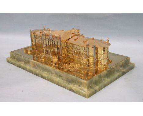 An 18ct gold model of The Old Grand Hotel at Ramsar, Iran, by Garrard &amp; Co. Ltd, Crown Jewellers, London W1.
The two wing