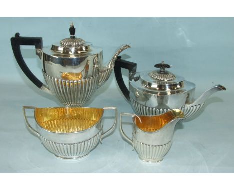 A four-piece tea and coffee service of oval half-gadrooned form, Chester 1913, (coffee pot 1911), inclusive weight ___61oz.