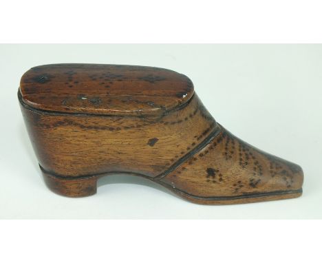 A 19th century mahogany snuff box in the form of a shoe with sliding lid and stud work decoration, 9.5cm long.