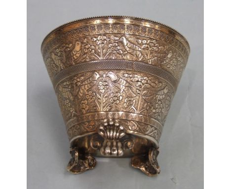 A 19th century Eastern silver gilt sugar basin of tapered cylinder form, with beaded rim, embossed with bands of flowers and 