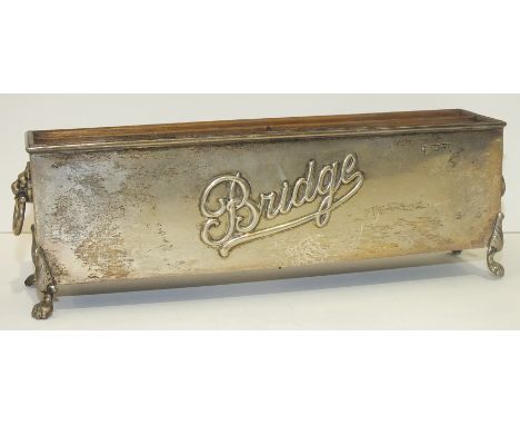 A rectangular playing card trough, embossed with the word "Bridge", raised on claw feet, 23cm long, Chester, 1906.