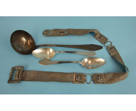 An Indian white metal belt, (some damage), two white metal spoons and a ladle, (4).