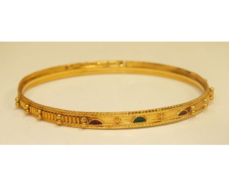 A modern yellow metal bangle with beaded and enamelled decoration, marked "21ct", 12g.