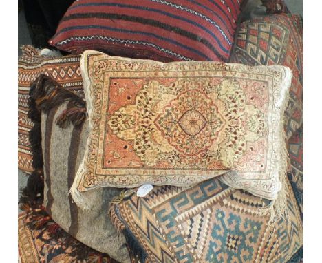 A collection of Afghan, Turkish and other 20th century carpet pieces as cushions.