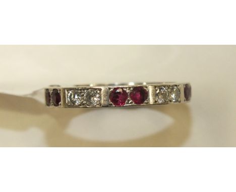 A diamond and ruby half-eternity ring set six round-cut rubies and four brilliant-cut diamonds, in unmarked white metal mount