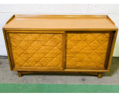 Mahogany sideboard by Nao with two sliding cupboards on square tapered legs, 129 x 43 x 74cms. Estimate £30-50.