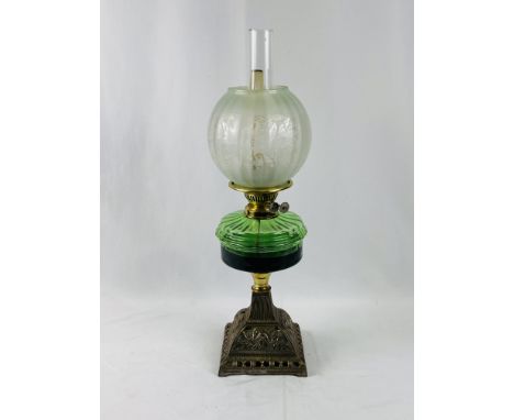 Victorian oil lamp with green glass reservoir, etched shade and cast metal base, 59cms. Estimate £40-60.
