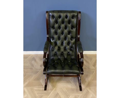 Mahogany framed green leather button back rocking chair with studded decoration throughout, 60 x 87 x 96cms. Estimate £80-120