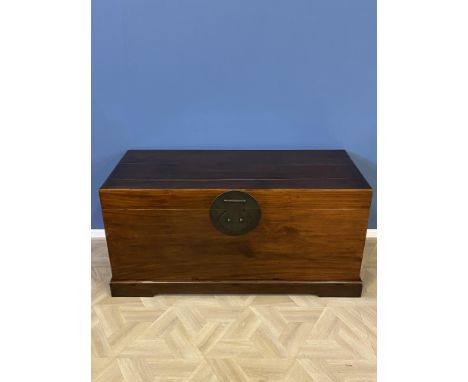 Large Chinese camphor wood chest with two brass carrying handles to each side, and a large brass circular locking plate to th