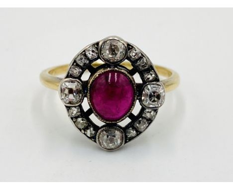Gold ring set with a centre ruby and diamond surround, 2.9g, size N 1/2. Estimate £1150-1400.