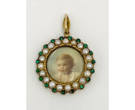 Portrait pendant with pearl and emerald surround on yellow metal mount, diameter approximately 3cms. Estimate £150-200