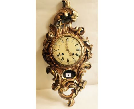 A C19th Swedish gilt Rococo style Cartell clock of acanthus scrolled form the enamel painted dial with fine gild brass hands 