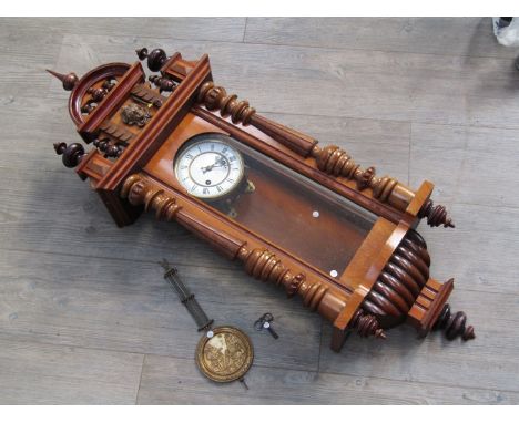 An early 20th Century Junghans 8 day spring driven wall clock of architectural form, walnut veneered case, Roman enamelled di