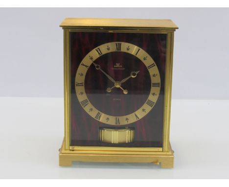 A Jaeger LeCoultre Atmos clock from the Embassy range, with faux red marble panels, in gilt brass and glazed casing, 21.75cm 