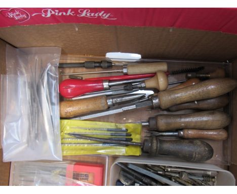 A collection of horologist's hand tools including let down keys, broaches, needle files, pin vices, screwdrivers, pliers, pun