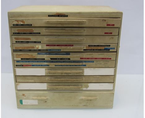 A vintage 10 drawer bench cabinet containing assorted watch balance staffs, mainsprings and other parts, various makes