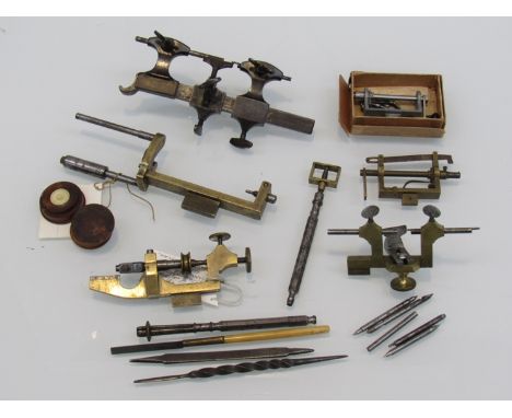 Mixed horology tools including mainspring winders, screw head polishers, Swiss and English turners with runners, oil pot, twe