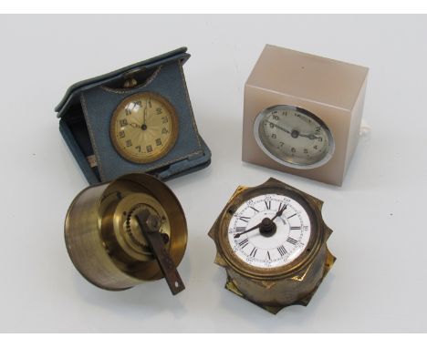 A travel timepiece in folding blue/gilt leather case, a miniature brass cased alarm clock and two others (4)