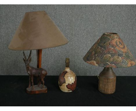 Two vintage glazed ceramic table lamps and another with a carved gazelle base. H.48cm (largest). 