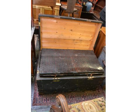 A vintage tin trunk in metal bound wooden travel case.