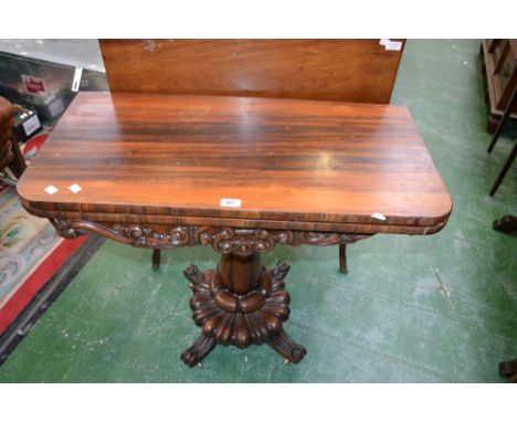 A William IV rosewood pedestal card table, rounded rectangular moulded top enclosing a baize-lined playing surface above a sh
