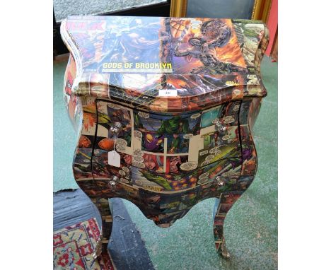 A  two drawer commode decorated with comic book type covers.