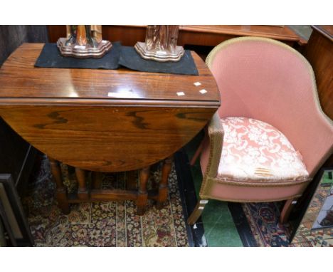 An oak dropleaf table; a Lloyd Loom style commode chair (2)