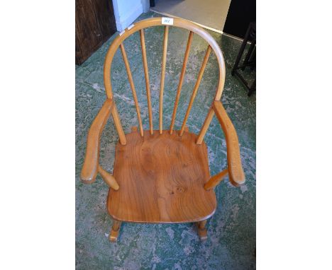 A spindle back Ercol style rocking chair