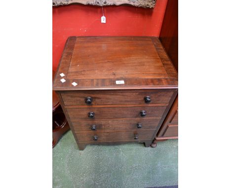 A George III mahogany commode in the form of a four drawer chest.