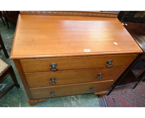 A 1930s oak chest of three drawers, brass escutcheons and handles, bracket feet 