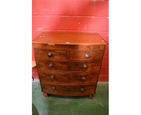 A Victorian mahogany bow front chest, two short cockbeaded flame mahogany fronted drawers over three graduated long, button h