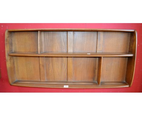 An Ercol wall mounted plate rack 