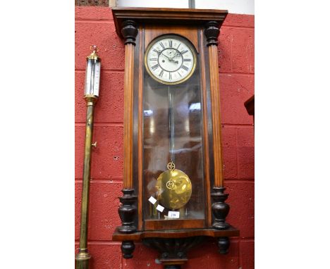 A large mahogany Vienna wall clock, enamelled dial, Roman numerals, door flanked by turned pilasters  