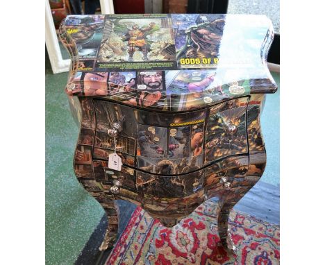 A  two drawer commode decorated with comic book type covers.
