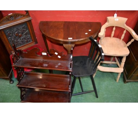 A mahogany hall chair, arched top rail, back flora carved in relief, padded seat; a mahogany three tier wall shelf, two short