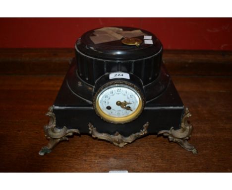 A black slate clock set as a gilt mounted plinth 