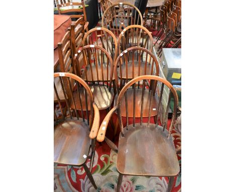 Two Ercol spindle back carvers; four Ercol spindle back dining chairs; an Ercol armchair (7)