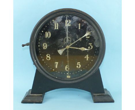 A 1930's novelty keyless mantle clock, the circular black dial with centrally-mounted counter balance pendulum and escapement