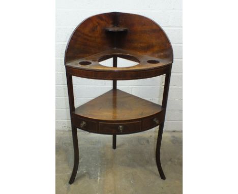 A Georgian mahogany corner wash stand fitted for a wash basin, 57cm wide, 104cm high.