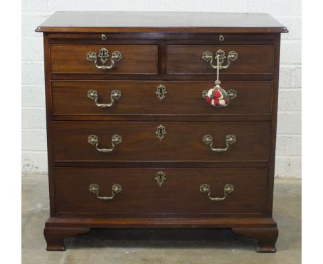 A Georgian mahogany bachelors' chest, the rectangular top above a brushing slide, two short and three long cockbeaded drawers
