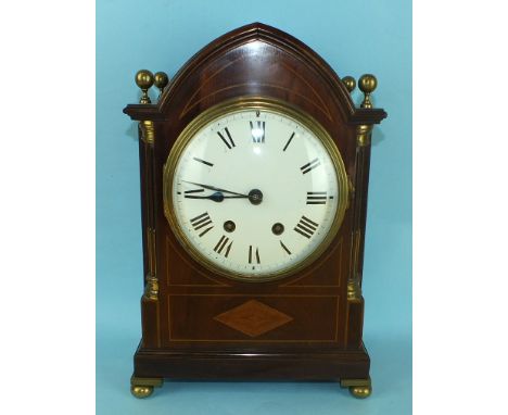 An Edwardian mahogany bracket clock, the lancet-shaped case with stop fluted pilasters, gilt metal finials and feet, the conv