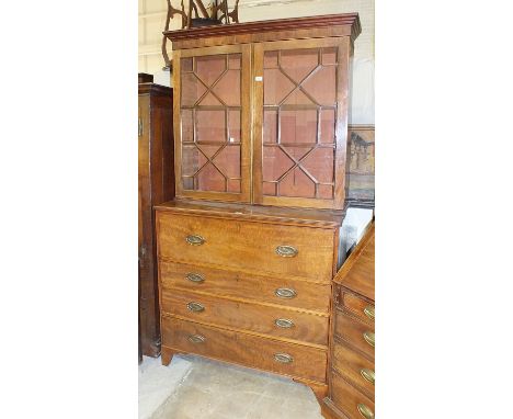 A Georgian mahogany secretaire bookcase, having a pair of astragal glazed doors above a fitted writing drawer and three cockb